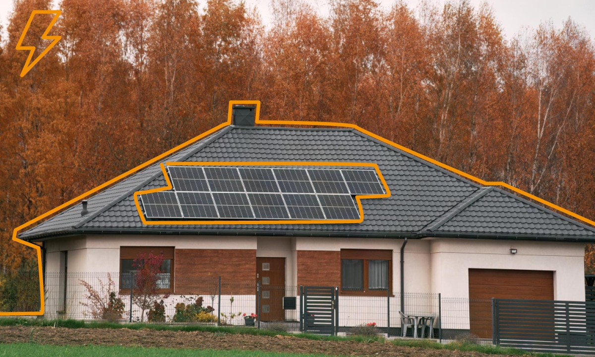 Dom s fotovoltickými panelmi na čiernej streche.