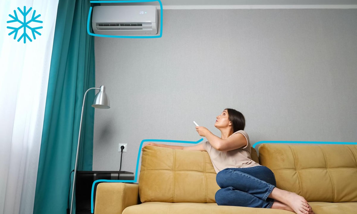 Žena sediaca pod klimatizáciou Samsung, nastavujúca teplotu chladenia cez ovládač.